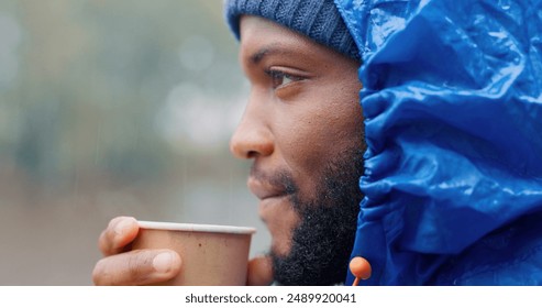 Tea, morning and black man drinking outdoor in winter storm as person for hiking, travel and relax. Hot coffee, peace and freedom in nature for adventure, camping and rain with latte as tourist - Powered by Shutterstock