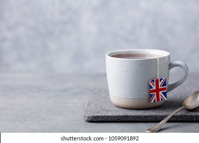 Tea In Mug With British Flag Tea Bag Label. Grey Background. Copy Space.