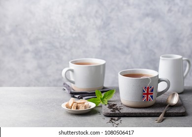 Tea In Mugs With British Flag Tea Bag Label. Grey Background. Copy Space.