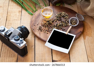 Tea , old camera and note paper composition with background