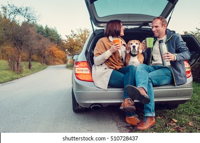 Tea Party In Car Trunk - Loving Couple With Dog Sits In Car Trunk