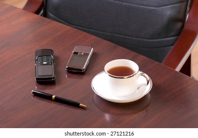 tea, pen and two cellulars
