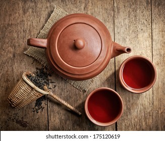 Tea Pot And Cups On Wooden Table