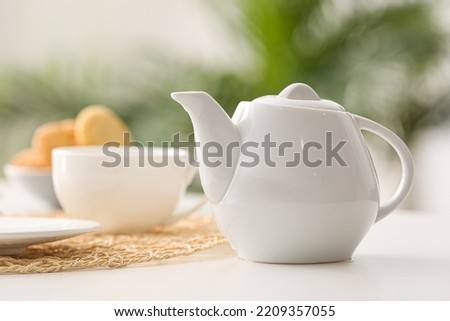 Tea pot on table in cafe