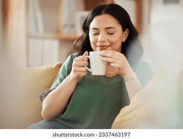 Tea, relax and smile with a woman in her home, sitting on a sofa in the living room enjoying a beverage. Peace, quiet and eyes closed with a happy young female person drinking coffee in her house - Powered by Shutterstock