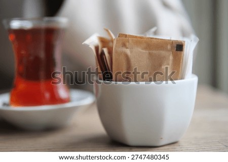 Tea served with sugar packets in a cafe setting