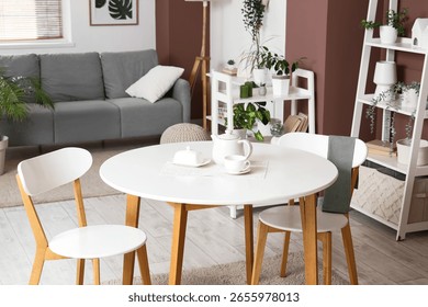 Tea set on dining table in living room interior