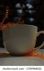 Tea Splashing Out Of Plain White Mug. 