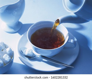 Tea With Sugar Cube And Spoon In Cup On The Table In House, Tea With Sugar Cube And Spoon In Cup, Food And Drink, Celebration.