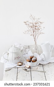 Tea Time With Coconut Sweets And Dried Flowers On Total Wooden White Table