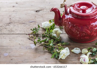 Tea Time Concept/red Chineese Tea Pot And White Tea Roses On Wooden Table