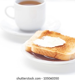 Tea And Toast With Butter Isolated On White