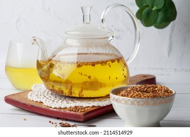 
Tea in a transparent teapot. Place for text. Buckwheat tea and granules.