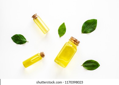 Tea Tree Essential Oil Near Tea Tree Leaves On White Background Top View