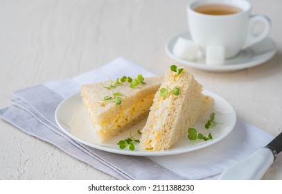 Tea Triangular Sandwiches With Egg Salad On A White Plate On A Light Concrete Background. Sandwich Recipes. Easter Food