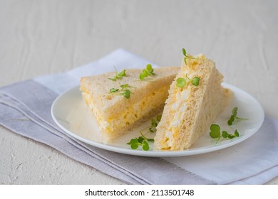 Tea Triangular Sandwiches With Egg Salad On A White Plate On A Light Concrete Background. Sandwich Recipes. Easter Food