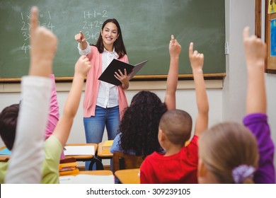 Teacher asking her students a question at the elementary school - Shutterstock ID 309239105