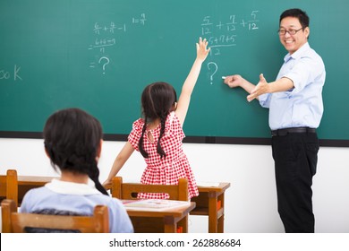 teacher asking question with children  in classroom