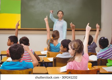 Teacher asking a question to her class at the elementary school