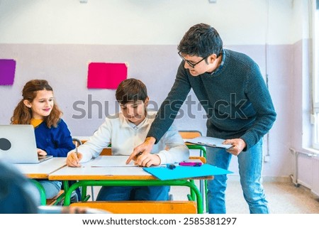 Teacher assisting students in the classroom, explaining concepts and correcting exercises while fostering a supportive learning environment