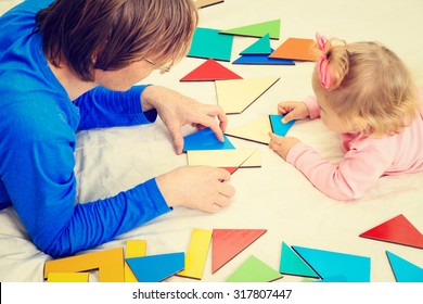 teacher and child playing with geometric shapes, early learning