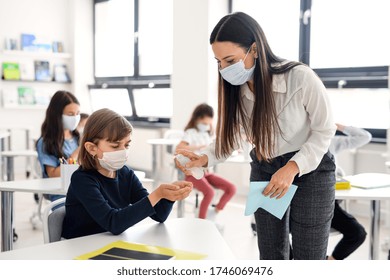 Teacher, Children With Face Mask At School After Covid-19 Quarantine And Lockdown.