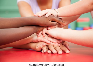 Teacher And Children With Hands Together