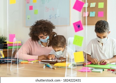 Teacher With Children Wearing Face Mask In Preschool Classroom During Corona Virus Pandemic - Healthcare And Education Concept