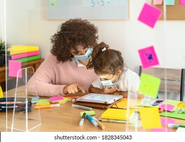 Teacher With Children Wearing Face Mask In Preschool Classroom During Corona Virus Pandemic - Healthcare And Education Concept