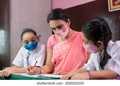 Teacher With Children Wearing Face Mask In Preschool Classroom During Corona Virus Pandemic