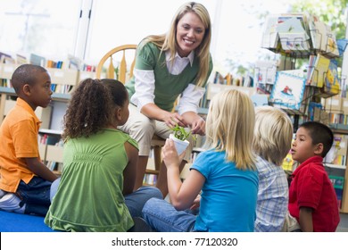 Teacher in class showing students bamboo plant - Powered by Shutterstock