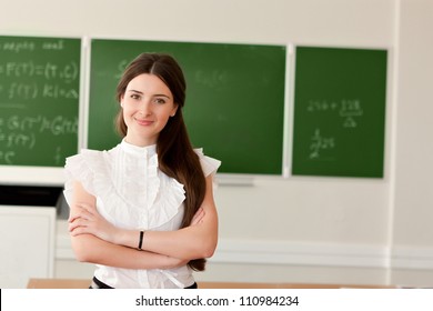 The teacher in the classroom on blackboard background. - Powered by Shutterstock