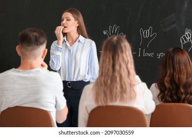 Teacher Conducting Courses For Deaf Mute People In Classroom