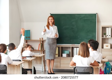 Teacher conducting lesson in classroom - Powered by Shutterstock