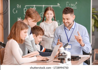 Teacher Conducting Physics Lesson In Classroom