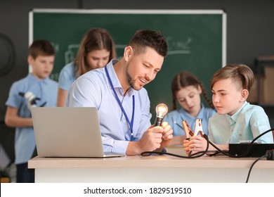 Teacher Conducting Physics Lesson In Classroom