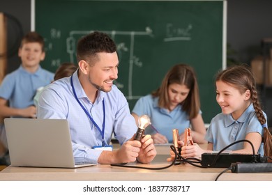 Teacher Conducting Physics Lesson In Classroom