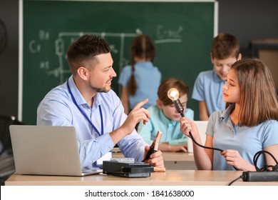 Teacher Conducting Physics Lesson In Classroom