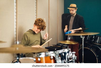 The Teacher Conducts A Drumming Lesson For A Teen Boy.