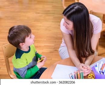 Teacher And Cute Boy Looking At Each Other - Supporting Child