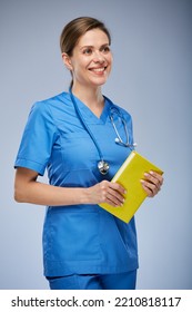 Teacher Doctor Or Student In Medical Suit With Yellow Book Looking Away. Isolated Portrait.