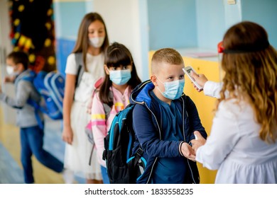 Teacher Doing Temperature Check On School Children 