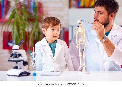 teacher explains a human body structure to little pupil - Powered by Shutterstock