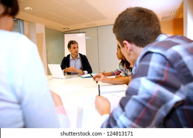 Teacher giving business presentation to students - Powered by Shutterstock