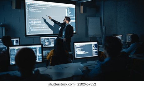 Teacher Giving Computer Science Lecture To Diverse Multiethnic Group Of Female And Male Students In Dark College Room. Projecting Slideshow With Programming Code. Explaining Information Technology.