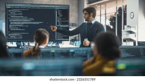Teacher Giving Computer Science Lecture to Diverse Multiethnic Group of Female and Male Students in a College Room. Projecting Slideshow with Programming Code. Explaining Information Technology - Shutterstock ID 2326351789