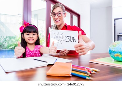 Teacher Giving English Language Lessons To Chinese Child