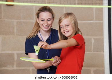 Teacher Giving Female Pupil Badminton Lesson - Powered by Shutterstock