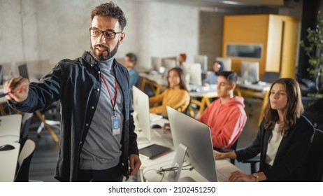 Teacher Giving Lesson To Diverse Multiethnic Group Of Female And Male Students In College Room, Learning New Academic Skills On A Computer. Lecturer Shares Knowledge With Smart Young Scholars.