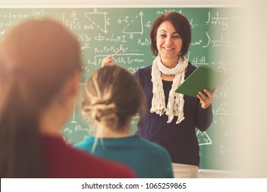 Teacher giving lesson to students in classroom - Shutterstock ID 1065259865